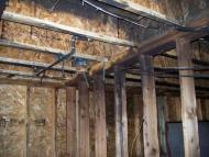 Fire damaged joists and wall studs.